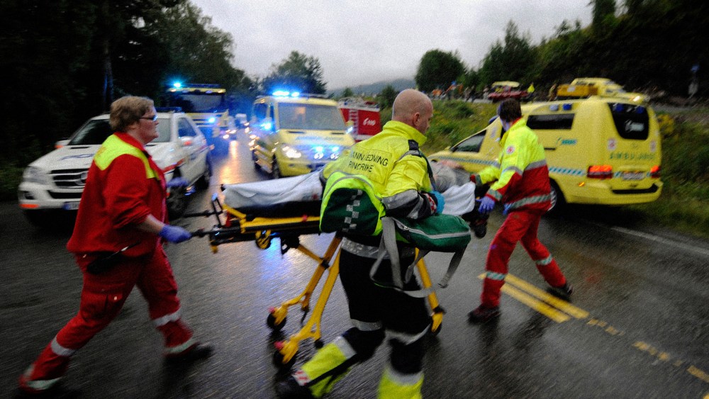 Image: Rescue workers evacuate a wounded person after a shooting on the Norwegian island of Utoya on July 23, 2011.