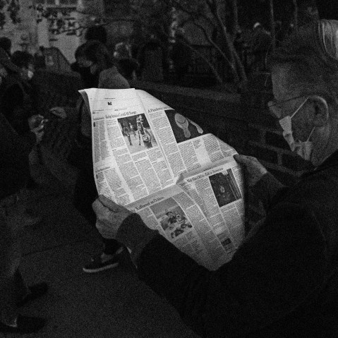 Image: John Winthrop reads a newspaper as he waits to vote in Charleston, S.C., on Nov. 3, 2020.