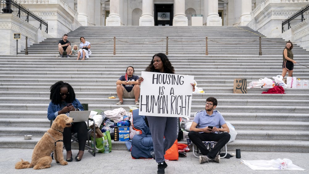 Rep. Cori Bush, D-Mo., center, joined by Congressional staffers and activists, protests the expiration of the eviction moratorium outside the Capitol on July 31, 2021.