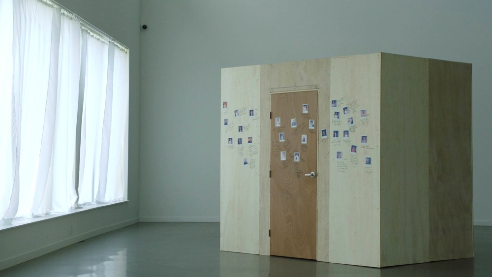 Image: A wooden box with photos on it in a room with a window.