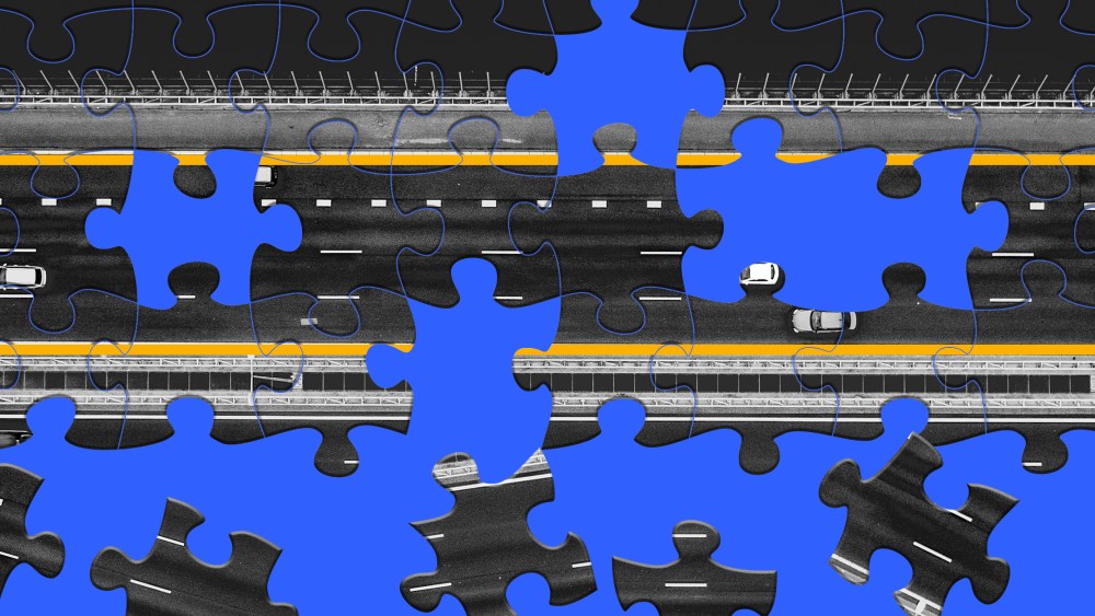 Photo illustration: An incomplete jigsaw puzzle with the image of a highway on a blue background.