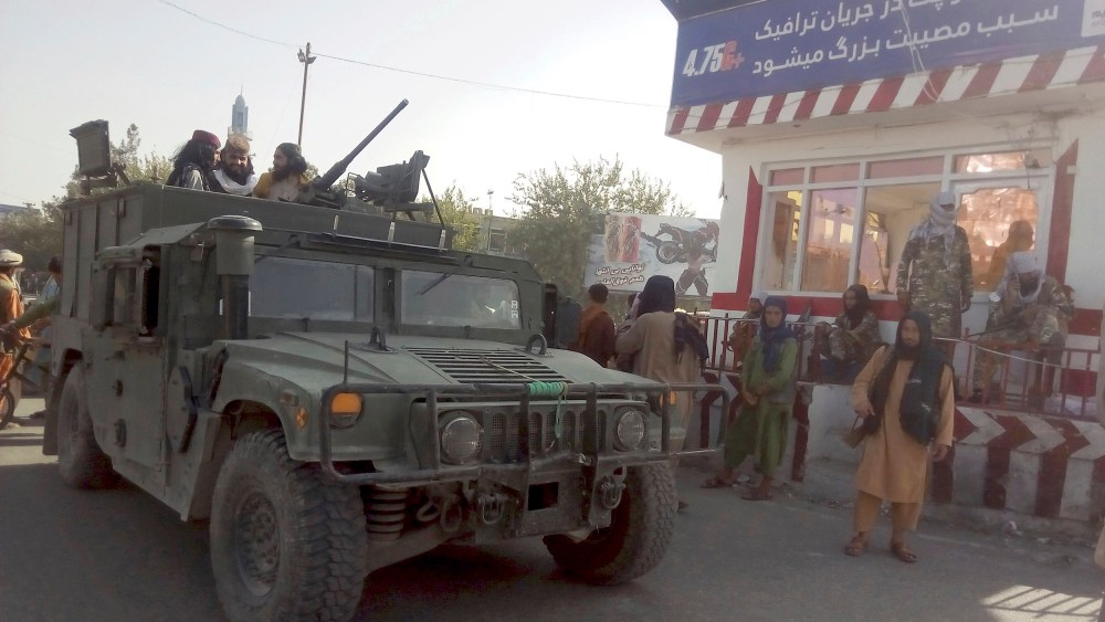 Image: Taliban fighters stand guard at a checkpoint in Kunduz city, northern Afghanistan