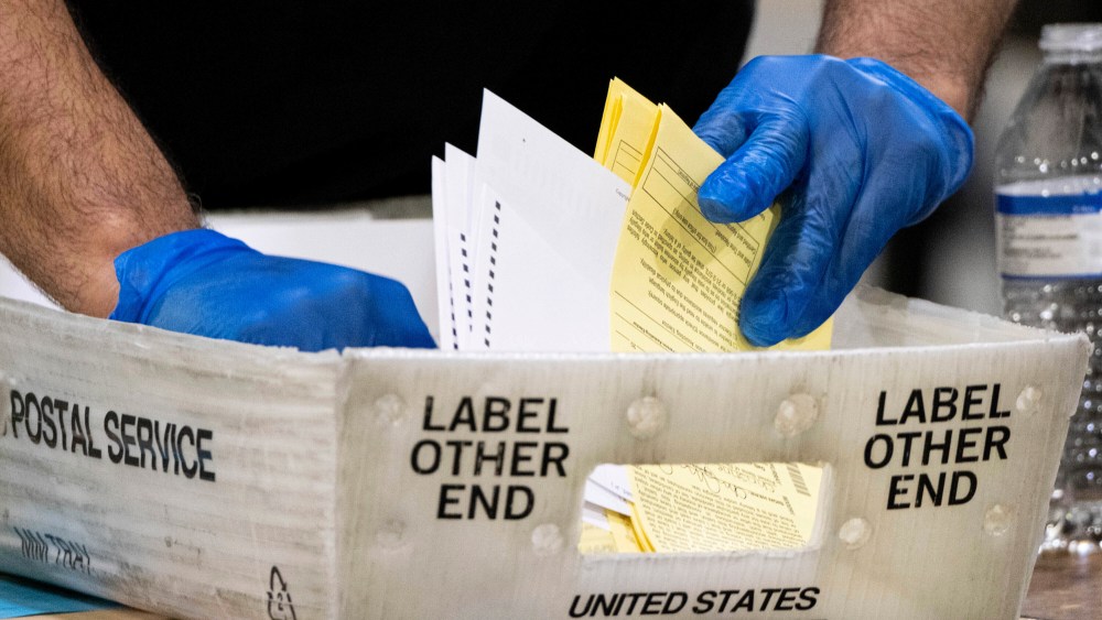 Fulton County Georgia elections workers process absentee ballots for the Senate runoff election in Atlanta on Jan. 5, 2021.