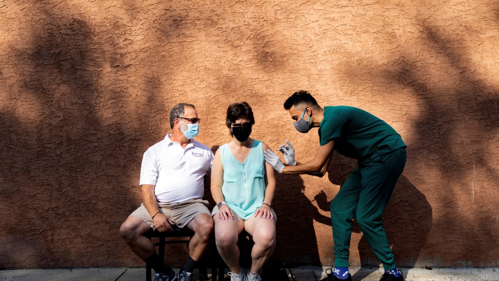 IMAGE: A woman receives a booster dose of the Pfizer-BioNTech Covid-19 vaccine at a pharmacy in Schwenksville, Pa., on Aug. 14, 2021.