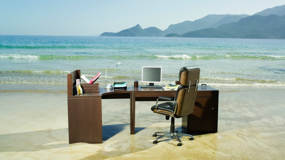 Office desk on beach.