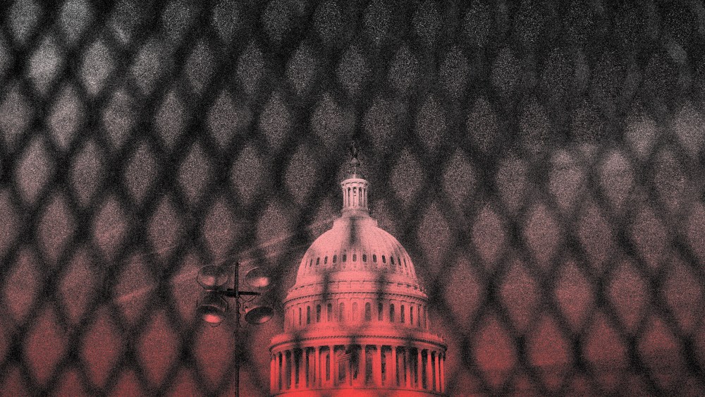 Image: The Capitol dome seen behind a security fence.