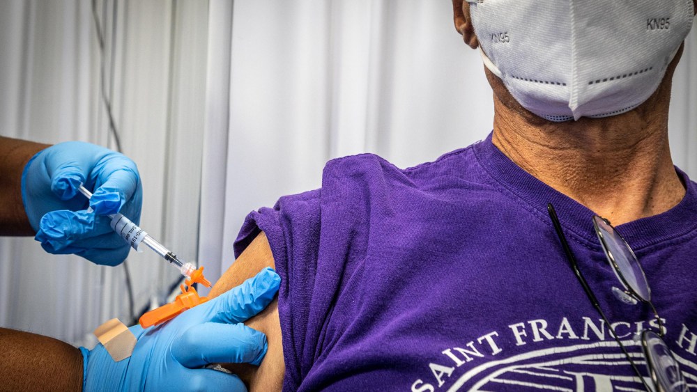 A man receives his third Covid-19 vaccine shot at Kennedy Memorial Park in Hempstead, N.Y., on Oct. 14, 2021.