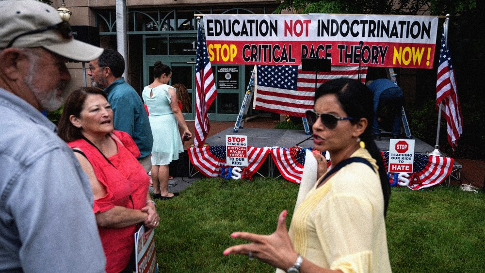 Image: People talk before a rally against critical race theory at the Loudoun County Government Center in Leesburg, Va., on June 12, 2021.