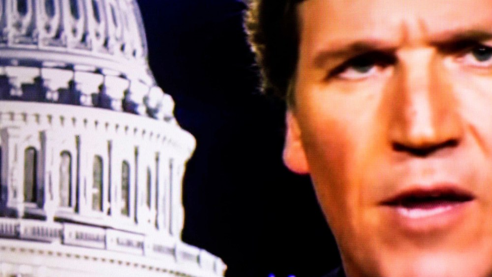 Image: Fox News anchor Tucker Carlson on a television screen in 2020.