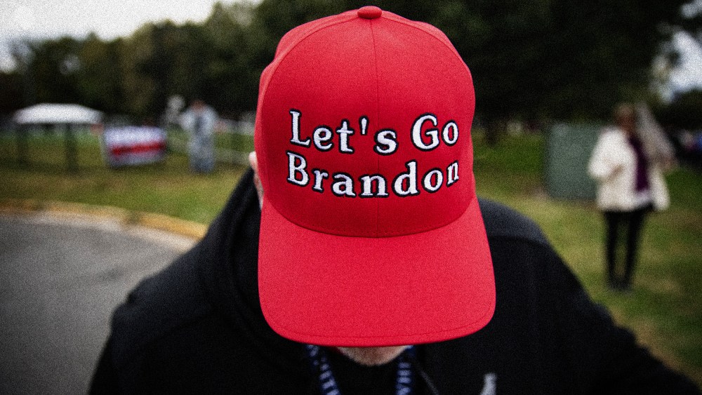 Image: A supporter of former President Donald Trump wears a "Let's Go Brandon" hat before a campaign event in Arlington, Va., on Oct. 26, 2021.