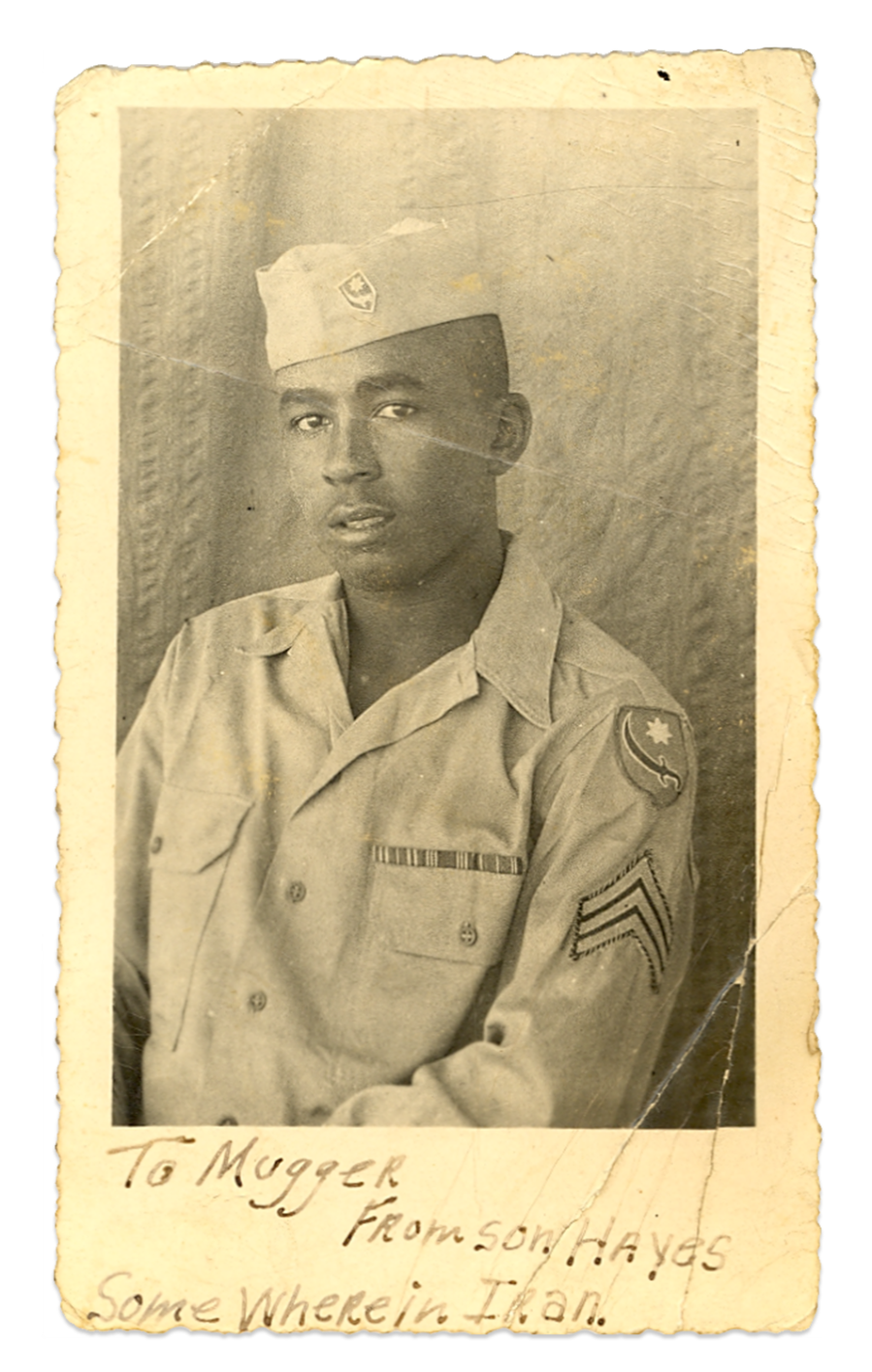 Image: Old photograph of a young man in army uniform. Handwritten text on it reads,