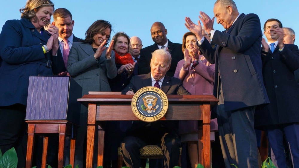 President Joe Biden, flanked by Vice President Kamala Harris, takes part in a signing ceremony for H.R. 3684, the Infrastructure Investment and Jobs Act on the South Lawn of the White House on Nov. 15, 2021.