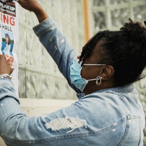 Image: A community member posts a missing poster of Amaria Hall.
