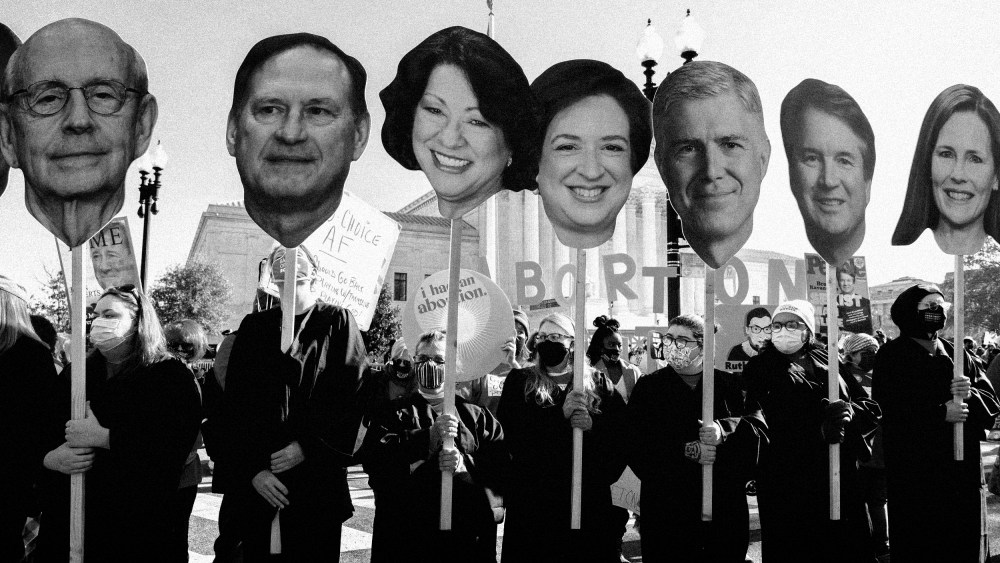 Image: Abortion rights advocates hold cutouts of the Supreme Court Justices as the court hears arguments in a Mississippi case where a 2018 law would ban abortions after 15 weeks of pregnancy on Dec. 1, 2021.