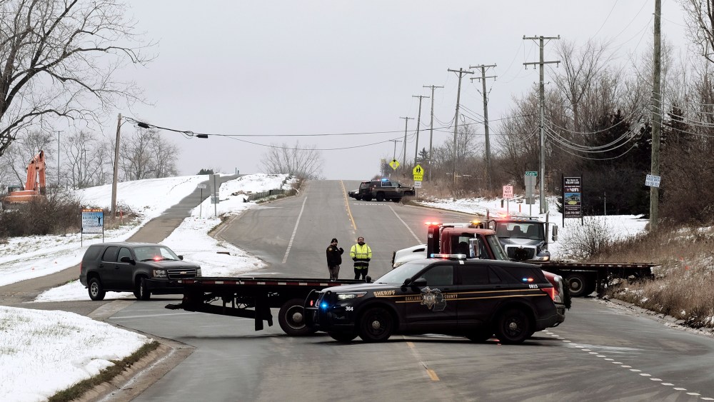 Image: Police cars blocking a road.