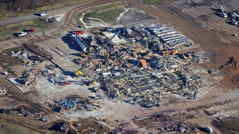Crews clear the rubble at the Mayfield Consumer Products candle factory on Dec. 13, 2021 in Mayfield, Ky.
