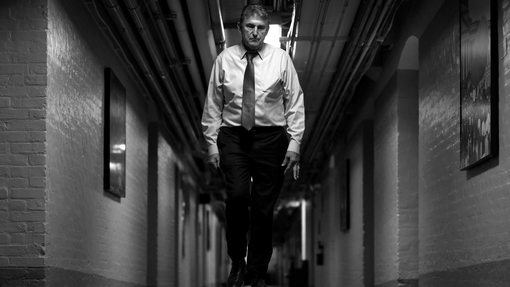 Image: Joe Manchin walks through a hallway.