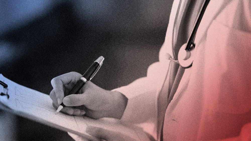 Image: A doctor writing a clipboard.