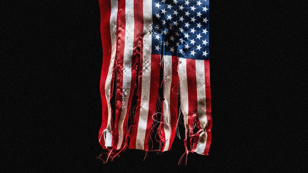 Image: tattered and torn American flag.