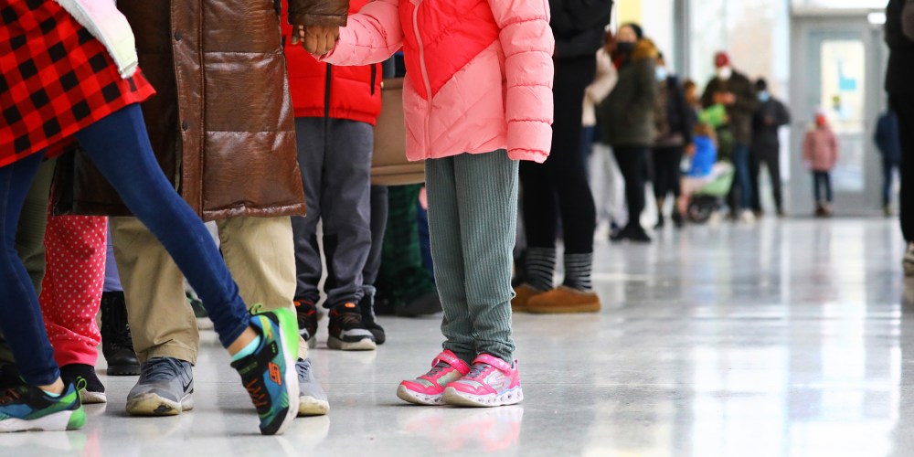 Image: Children stand in line to get tested for Covid-19.