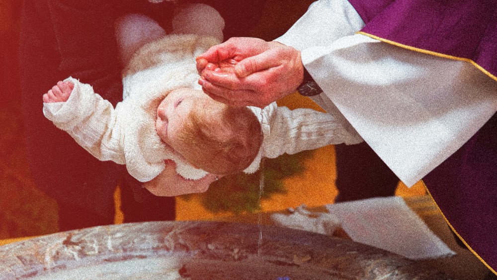 Image: Photograph of a priest is baptizing a baby in a church with a red color overcast.