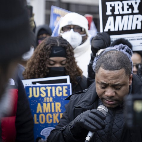 Image: Andre Locke, father of Amir Locke speaking to a crowd holding signs that read,"Frey lied Amir died" and "Justice for Amir Locke".