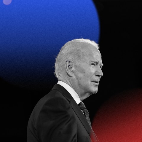 Photo illustration: A blue and red lens flare above an image of Joe Biden speaking.