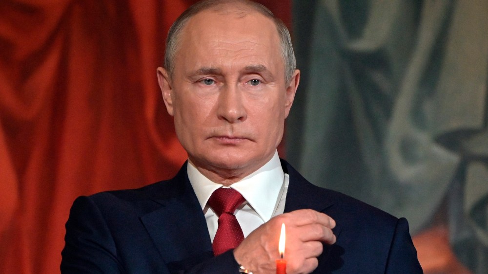 Image: Vladimir Putin crosses himself during the Easter service.