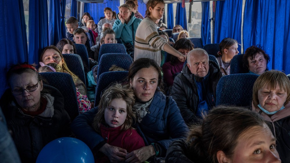 Image: Ukrainian evacuees on a bus carrying refugees, after crossing the Ukrainian border with Poland.