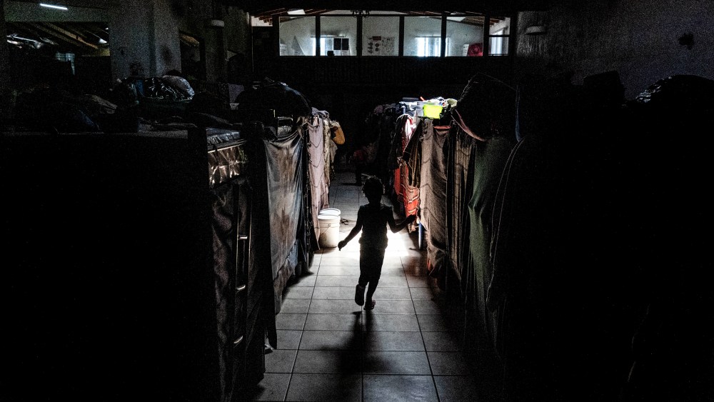 A migrant child plays between bunk beds at the Templo Embajadores De Jesus shelter in Tijuana, Mexico, on March 23, 2022.