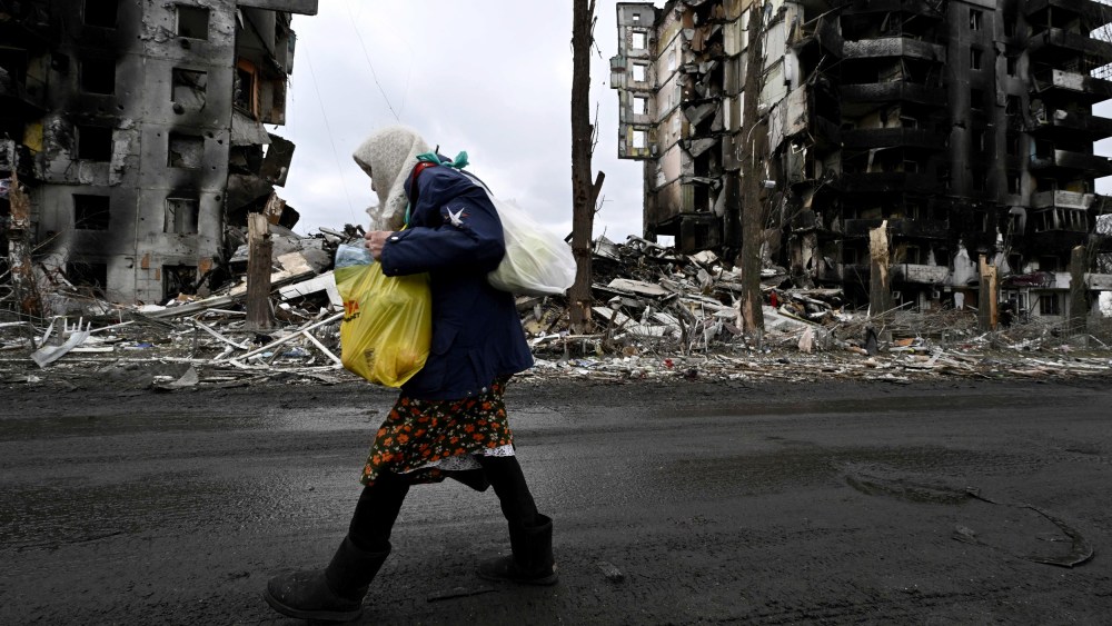 Image: A woman walks past a destroyed building in Borodianka, Ukraine, on April 6, 2022.