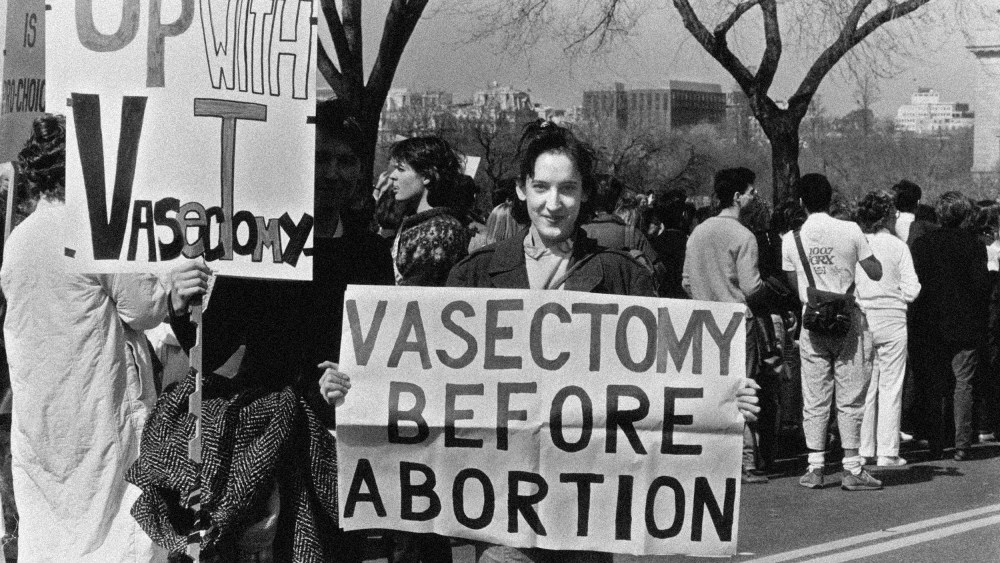 Image: Campaigners supporting vasectomy as a means of birth control before abortion at a National March for Women's Lives in Washington in 1986.
