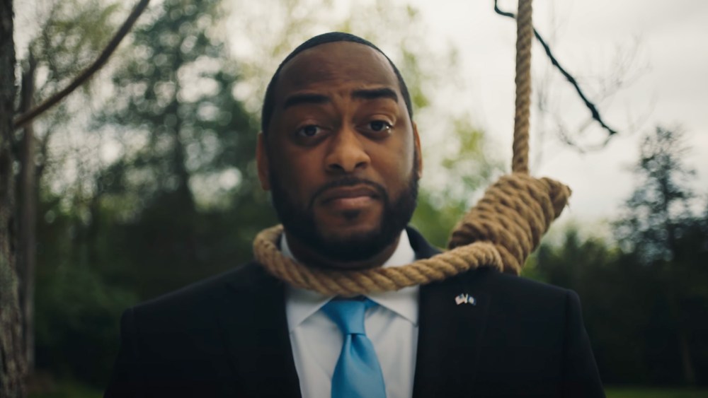 Image: Still from a campaign ad showing Charles Booker wearing a noose.