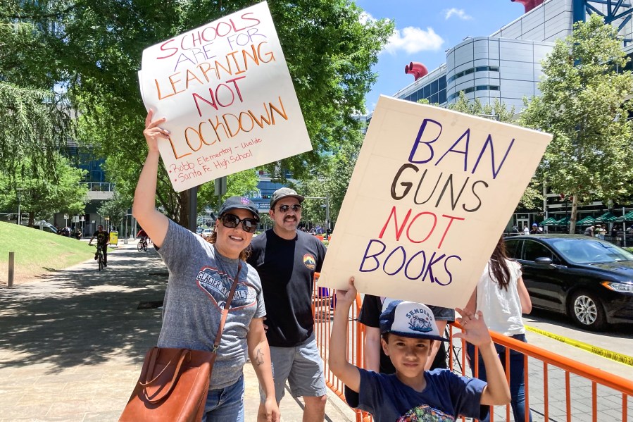 Houston teacher Nicole Santos attends the Saturday protest with her family outside of the NRA convention on May 28, 2022.