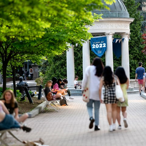 A Class of 2022 banner is displayed as students walk on campus at George Washington University in Washington, D.C., on May 2, 2022.