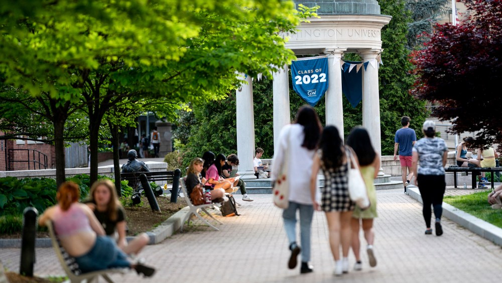 A Class of 2022 banner is displayed as students walk on campus at George Washington University in Washington, D.C., on May 2, 2022.