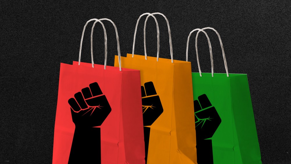 Photo illustration:Three red, yellow and green colored shopping bags with black colored fists on them.