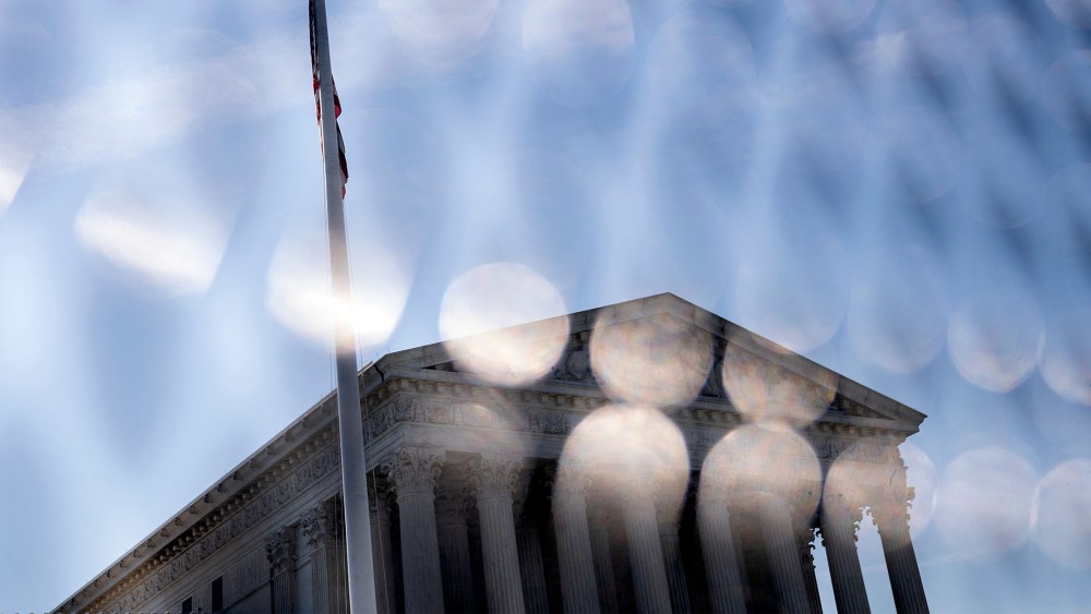 Image: Supreme Court seen through the temporary fencing around it.