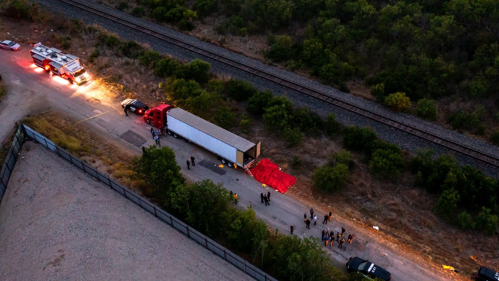 Image: Aerial view showing law enforcement officers investigating a tractor trailer.
