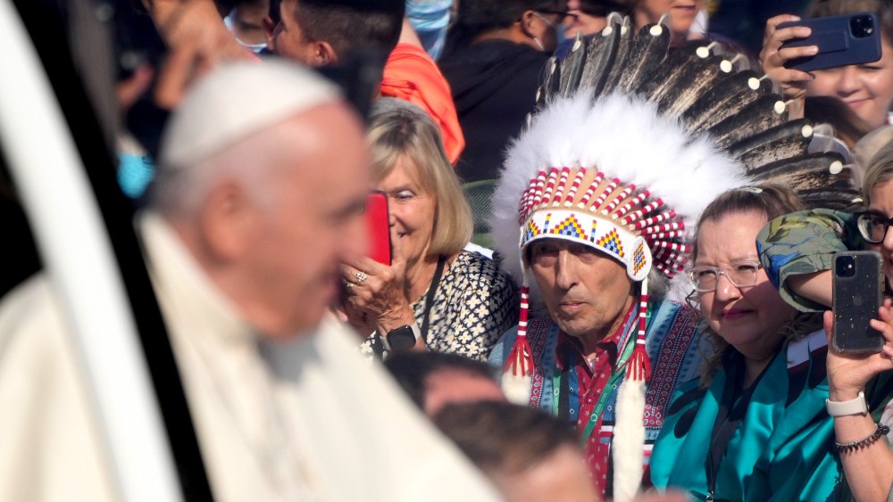 Image: Pope Francis arrives at the Commonwealth Stadium to celebrate mass as Phil Fontaine stands in the audience watching him.