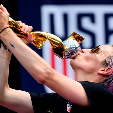 Image: Megan Rapinoe kisses the World Cup trophy during a ceremony at City Hall in New York on July 10, 2019.