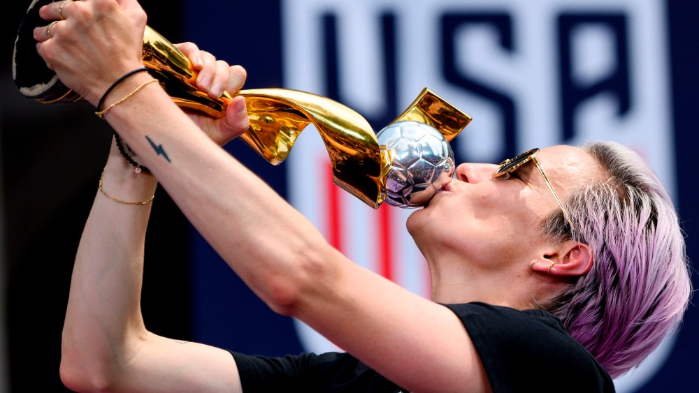 Image: Megan Rapinoe kisses the World Cup trophy during a ceremony at City Hall in New York on July 10, 2019.