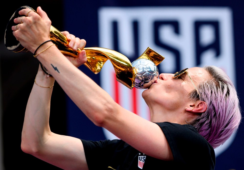 Image: Megan Rapinoe kisses the World Cup trophy during a ceremony at City Hall in New York on July 10, 2019.