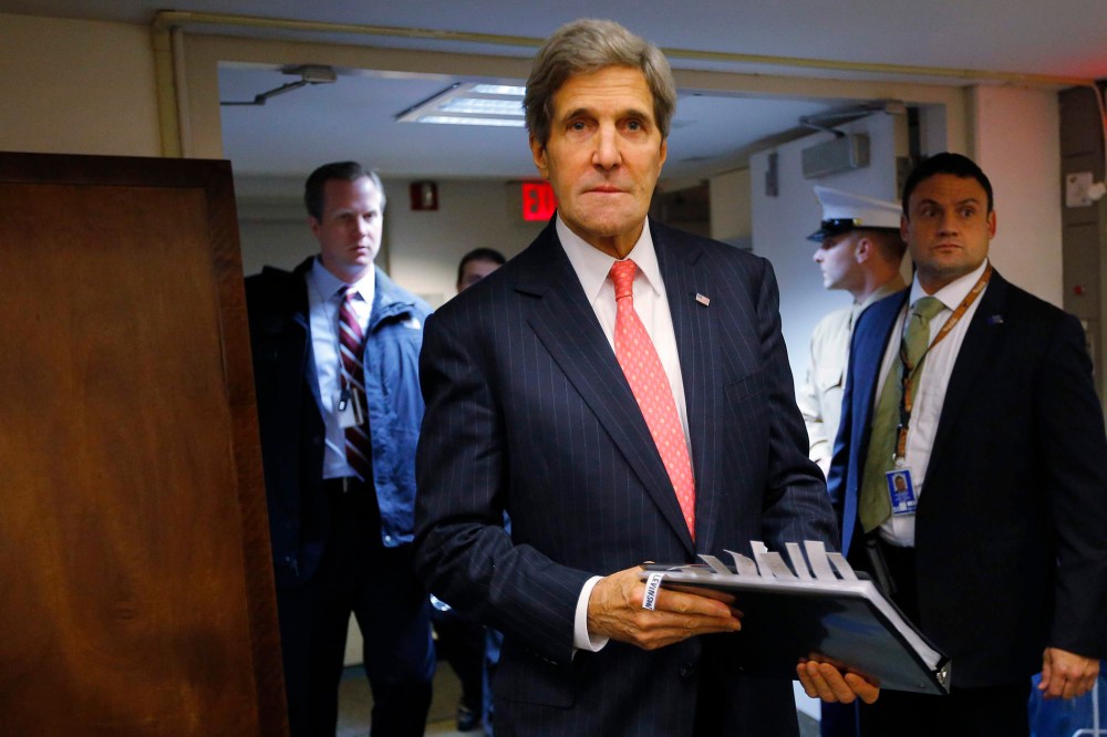 Secretary of State John Kerry enters the room for a news conference at the U.S. Embassy in Tel Aviv December 13, 2013.