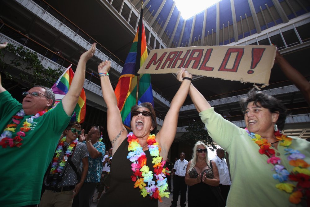 Tambry Young (C) and Debrah Zeleznik (R) celebrate after the Hawaii State Senate approves a bill allowing same-sex marriage to be legal in the state of Hawaii, in Honolulu November 12, 2013.