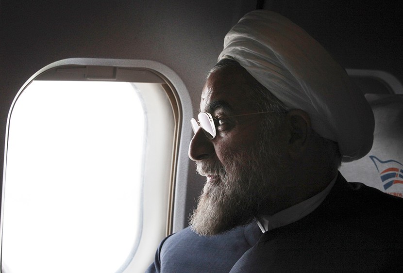 In this Monday, June 10, 2013, Iranian President, Hasan Rouhani, a former Iran's top nuclear negotiator, looks on, in his plane, during his presidential election campaign tour to the northwestern, Iran.  (Photo by Vahid Salemi/AP)