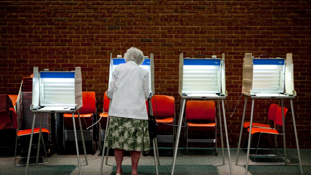 A voter casts her ballot in the primary election in Maryland Heights, Missouri, August 3, 2010.