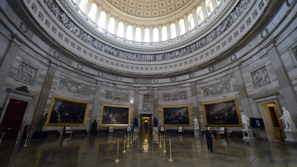 A Capitol police officer walks through the Capitol Rotunda, empty of visitors after being closed to tours, during the government shutdown on Capitol Hill in Washington, D.C., October 1, 2013.
