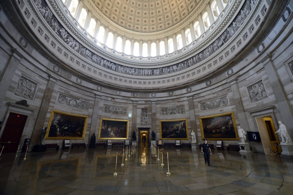 A Capitol police officer walks through the Capitol Rotunda, empty of visitors after being closed to tours, during the government shutdown on Capitol Hill in Washington, D.C., October 1, 2013.