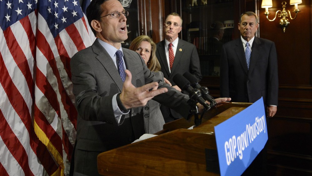 House Majority Leader Republican Eric Cantor (L) holds a news conference with other House Republicans following a Republican caucus meeting on Capitol Hill in Washington D.C., October 23, 2013.
